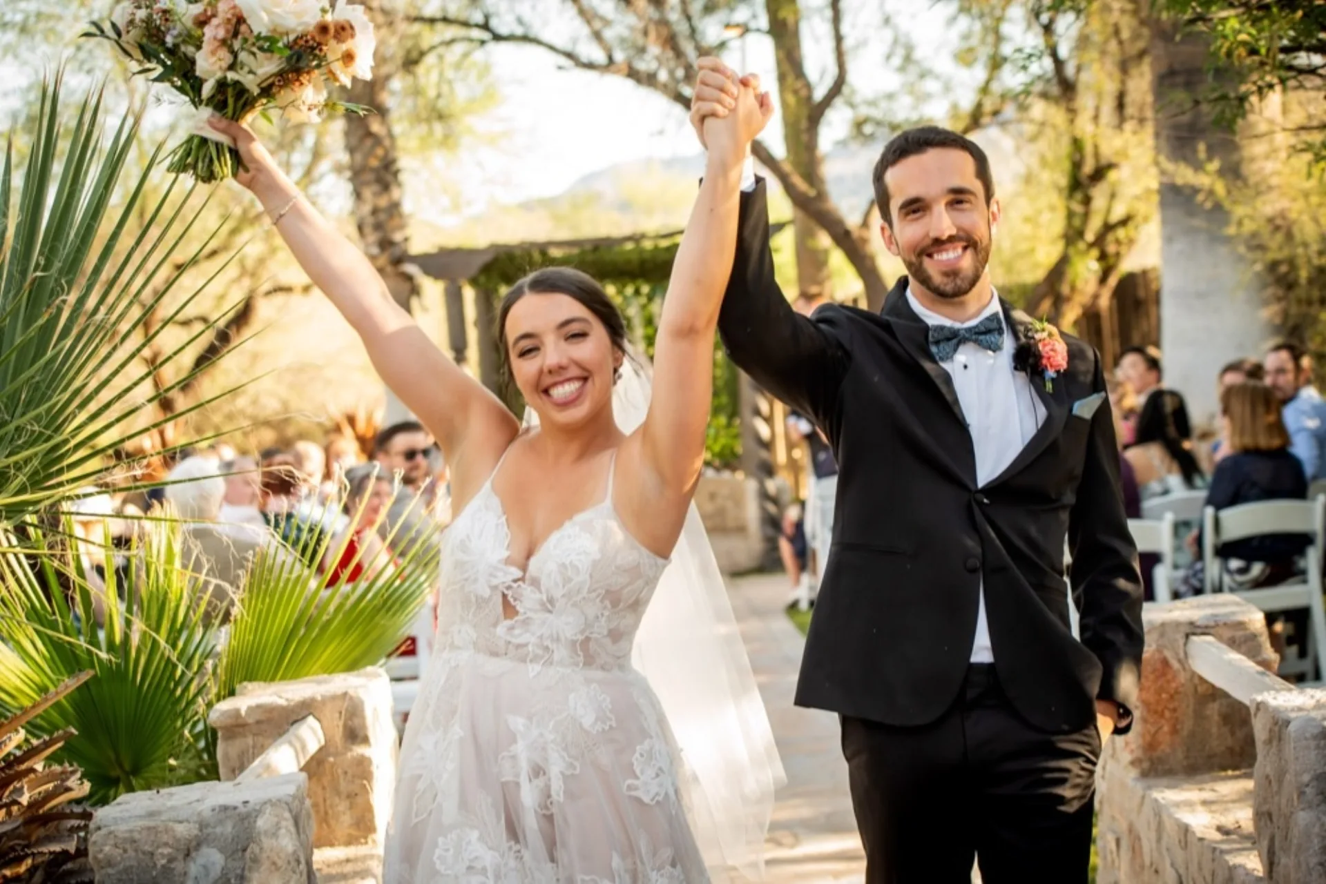 Bride and groom celebrating at indoor reception, Oasis at Wild Horse Ranch Tucson wedding venue